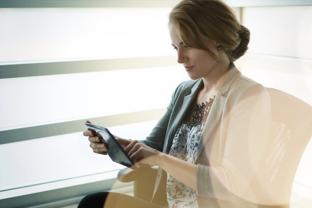 Filtered portrait of an executive business woman writing on a glass wall at sunset-1